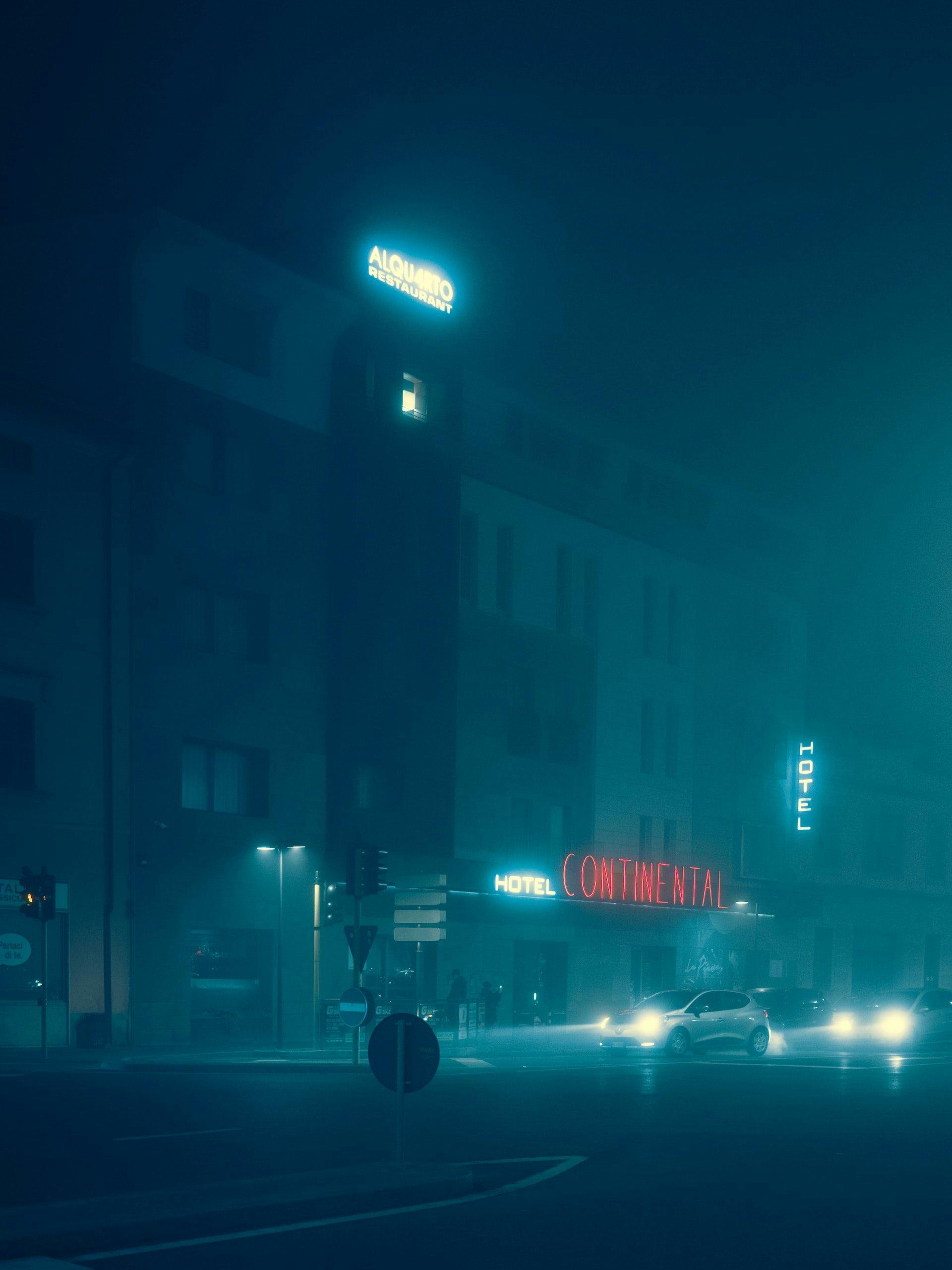 Foggy night with hotel neon sign in background